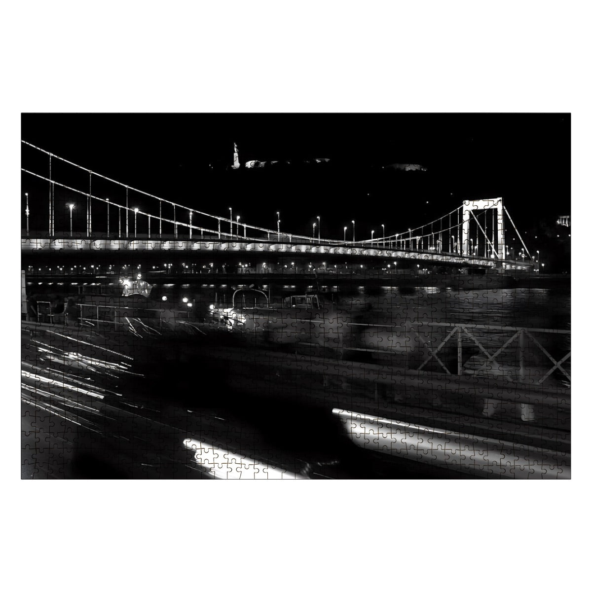 Full color photo of a historic bridge in Budapest with architectural buildings in the background.
