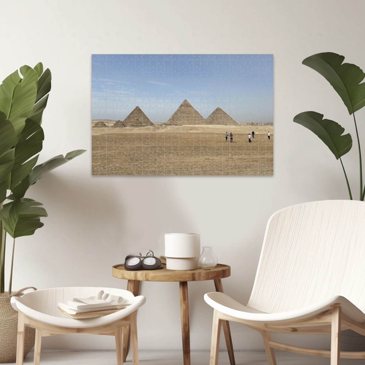 Full color image of the Pyramids of Giza under a blue sky with desert foreground and people in the distance.