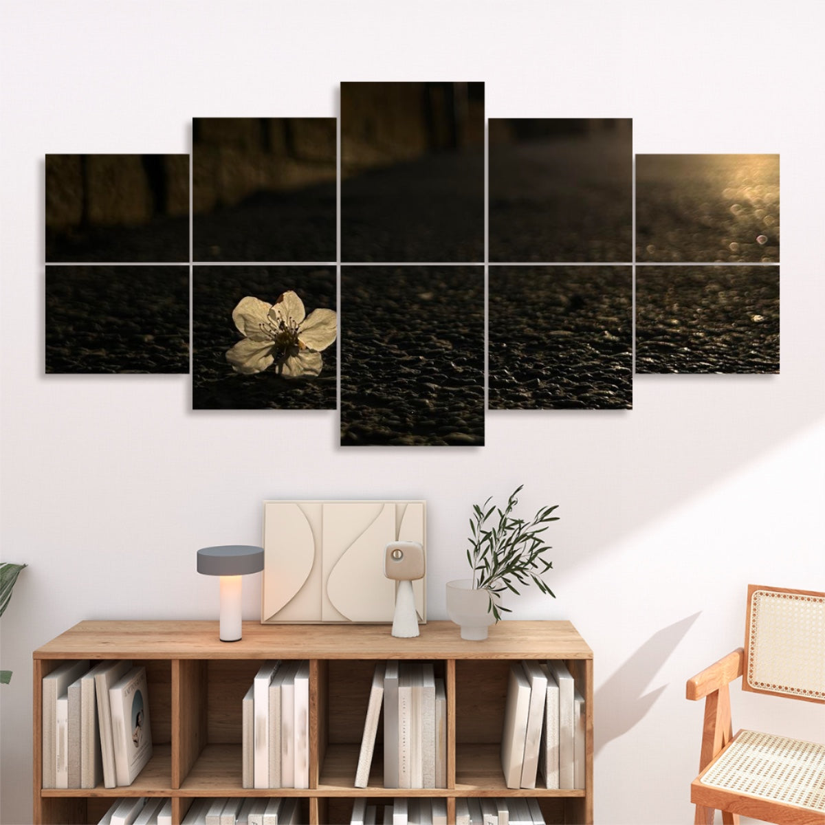 Single white flower resting on dark asphalt under golden sunset light, displayed across 10 decorative sound absorbing wall panels.