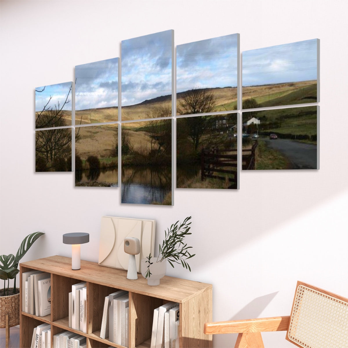 Right-angled view of full color wall panels with hilly terrain, cloudy sky, and a reflective pond.