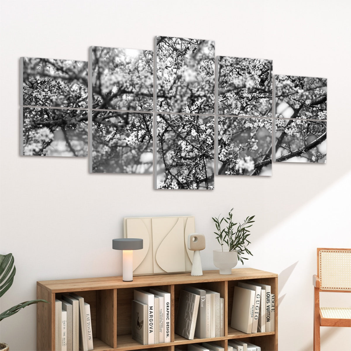 Left-angled view of black and white floral wall art with blurred branches and blossoms split between 10 acoustic panels.