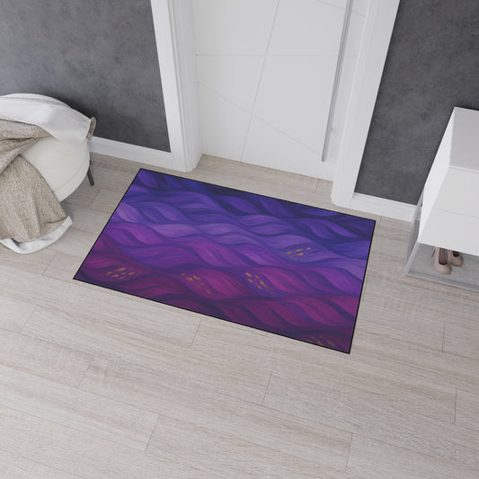 Large-format floor mat (36x60) with a dramatic, abstract wave design in plum and violet, positioned in a bright entryway with light wood flooring.