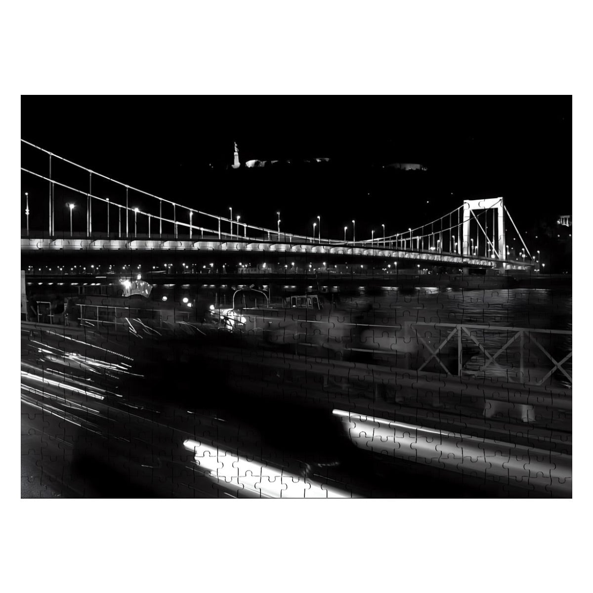 photograph of a Budapest bridge with historic architecture and river backdrop.