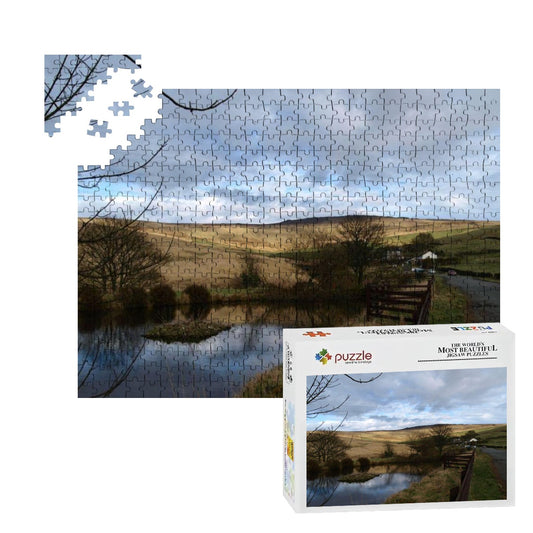500-piece wooden puzzle showing a golden British landscape with trees and pond, in natural soft color tones.