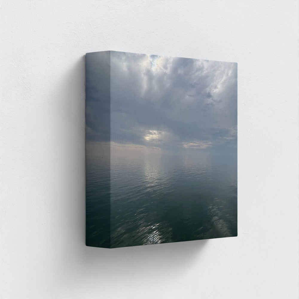 8''x8'' side-angle view of sustainable canvas art depicting mirrored clouds on a calm sea