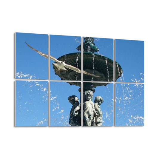 Angled left-side view of full-color acoustic wall panels showing a Lisbon fountain with detailed sculpture and a flying bird, with water arcs catching sunlight.