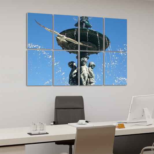 Angled left-side view of full-color acoustic wall panels showing a Lisbon fountain with detailed sculpture and a flying bird, with water arcs catching sunlight.
