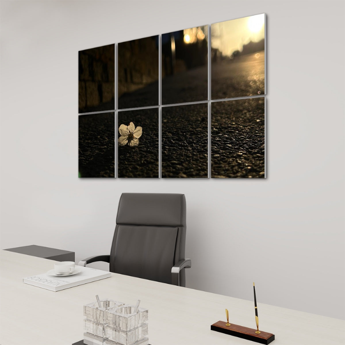 Right side perspective of full-color sound-absorbing wall panels displaying a white flower on asphalt in golden hour lighting.