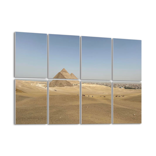 Left-angle view of Distant Pyramids wall art in full color showing desert textures, foreground figures, and the pyramids rising subtly on the horizon.