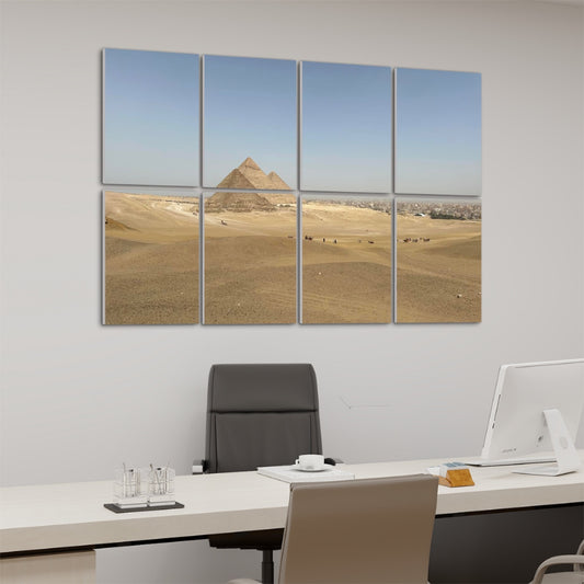 Office mock-up of Left-angle view of Distant Pyramids wall art in full color showing desert textures, foreground figures, and the pyramids rising subtly on the horizon.
