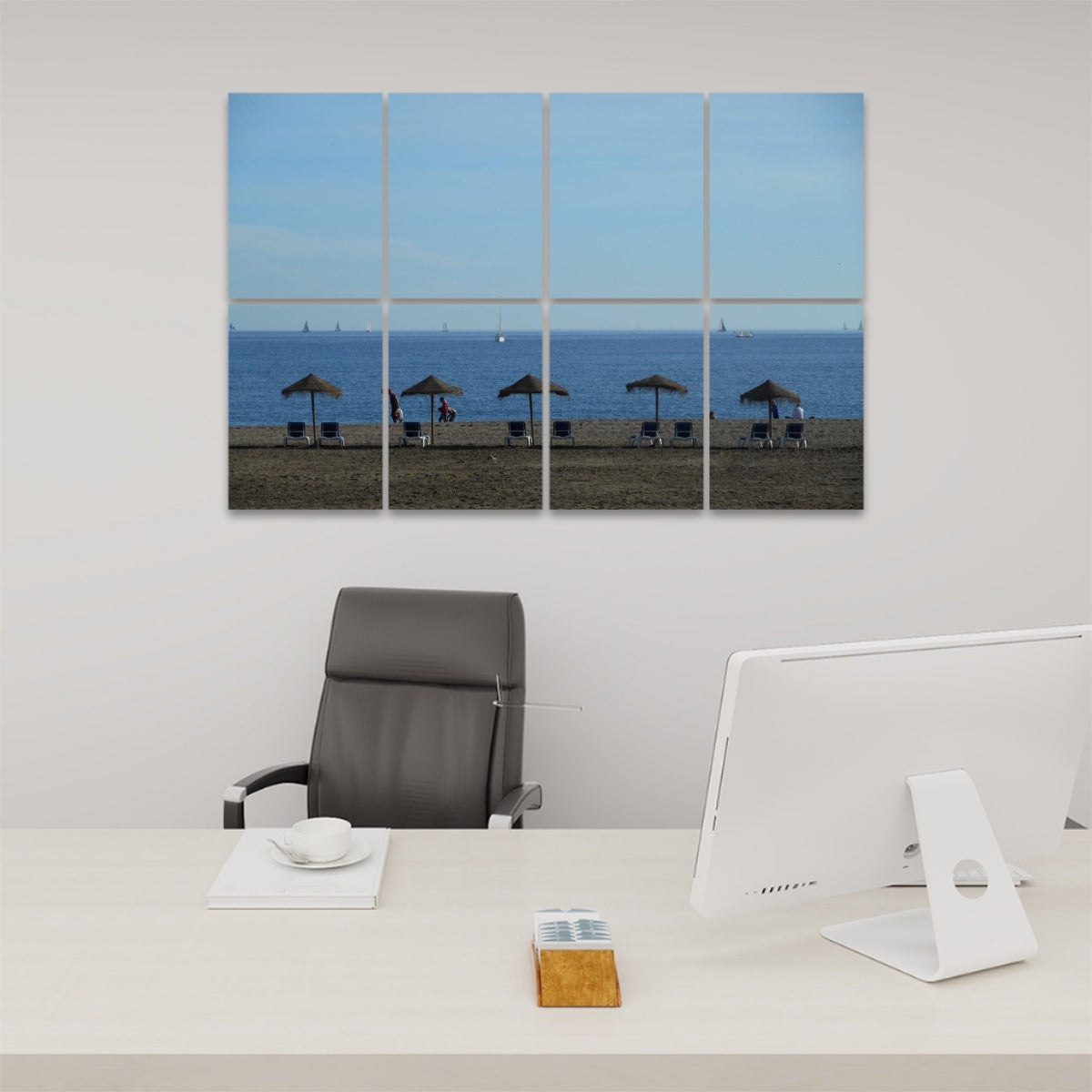 Eight-panel acoustic wall art showing a wide, quiet beach in Málaga, Spain with straw umbrellas, empty lounge chairs, and a soft blue sky over calm sea.