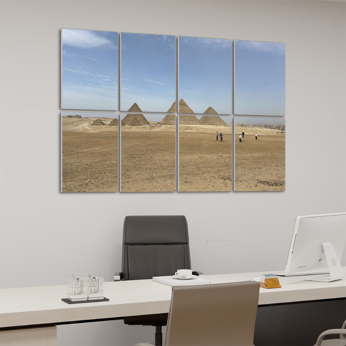 Wide desert landscape with people walking toward the Pyramids of Giza under a blue sky, printed across 8 sound-absorbing wall panels. left angle view