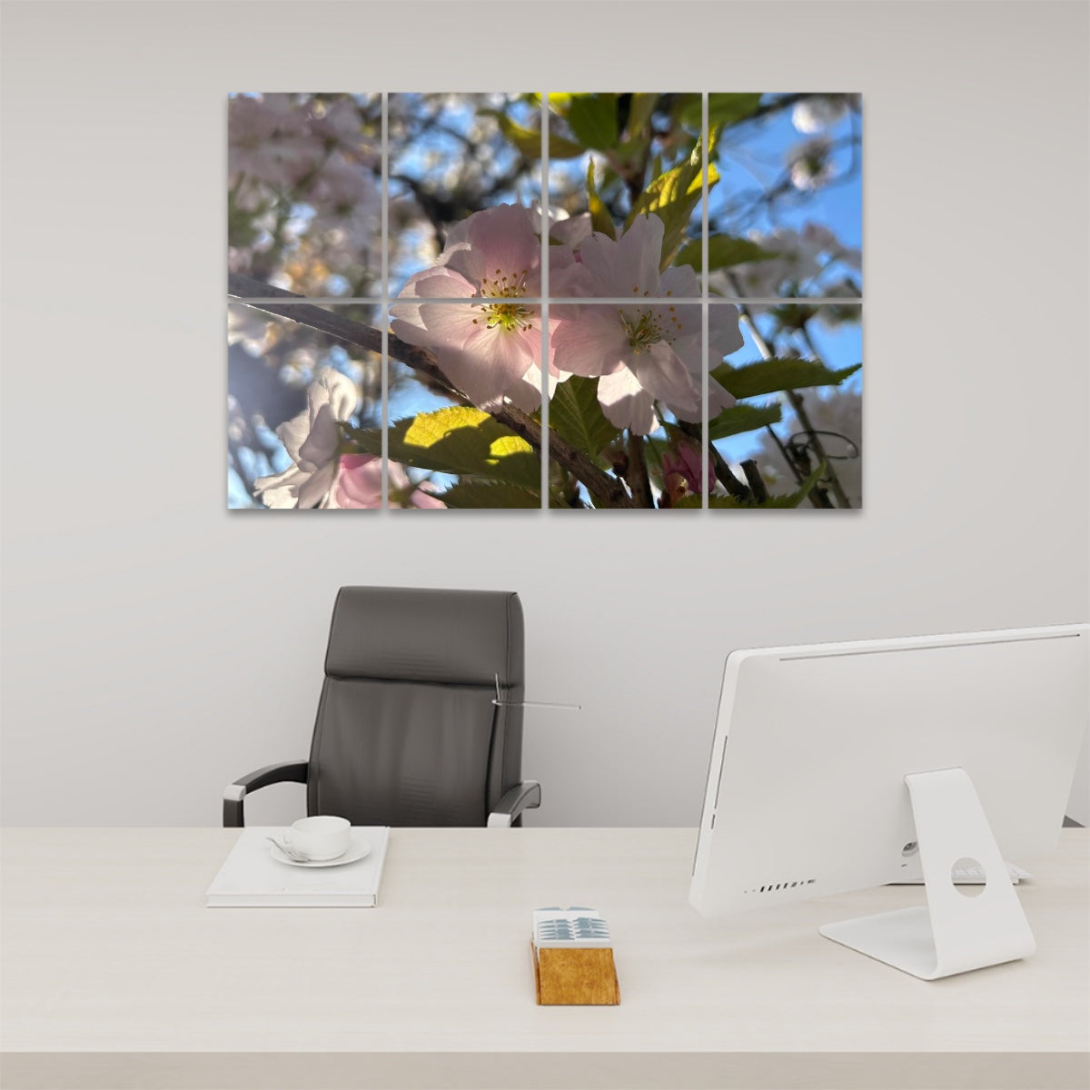 Pale pink blossoms in sunlight with soft green leaves and blue sky, split between 8 decorative sound absorbing wall panels.