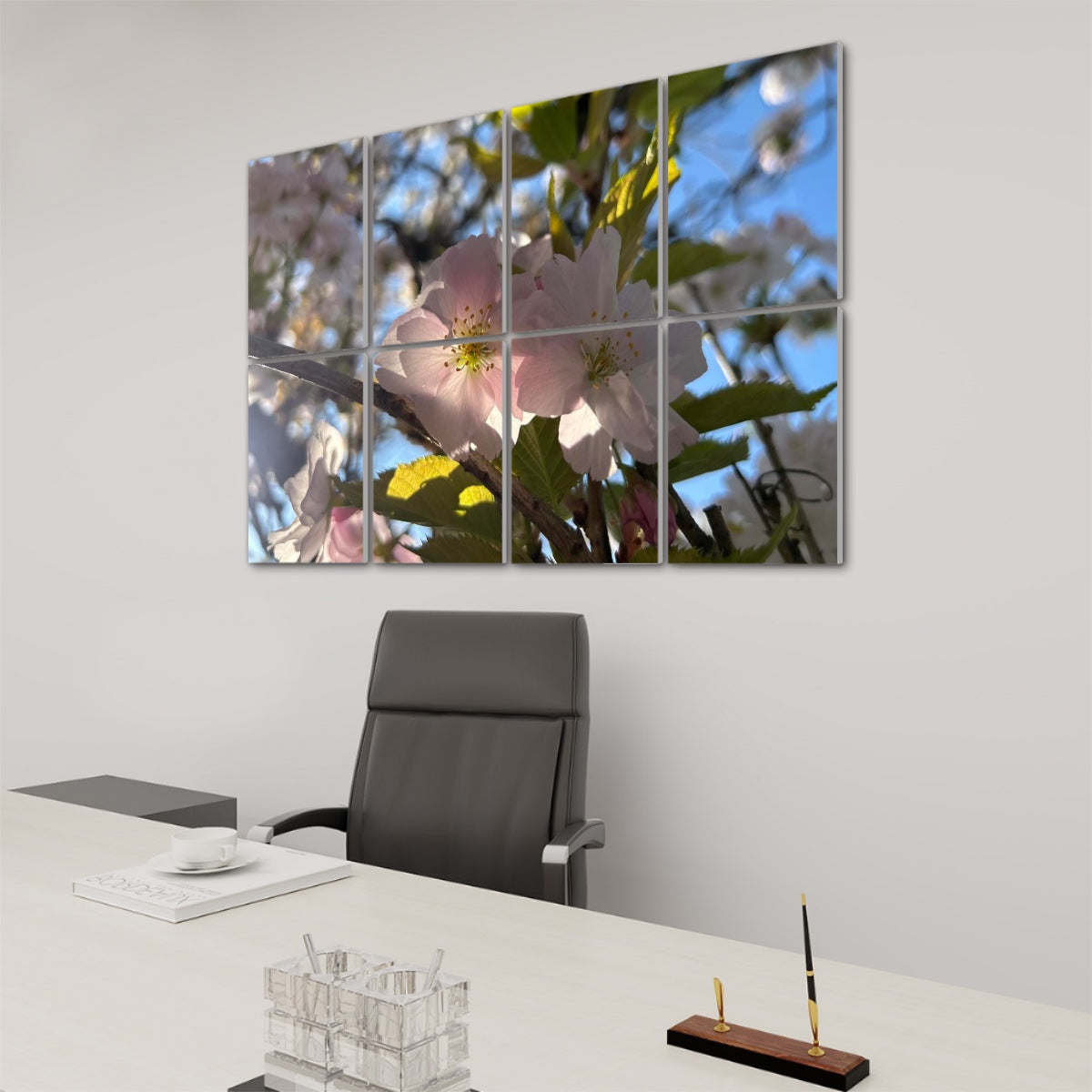 Right angle view of 8 decorative sound absorbing panels showing pale flowers and green branches in gentle daylight.