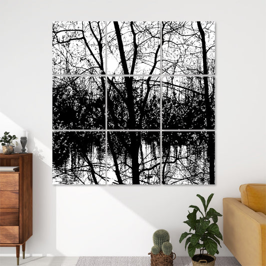 Black and white 9-panel acoustic wall art showing silhouetted spring branches over a reflective lake, with strong contrasts and natural light.