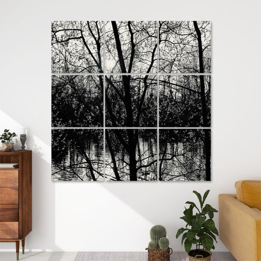 Front view of 9-panel acoustic wall art featuring blossoming tree branches silhouetted against a reflective lake surface with spring sunlight breaking through forest trees.