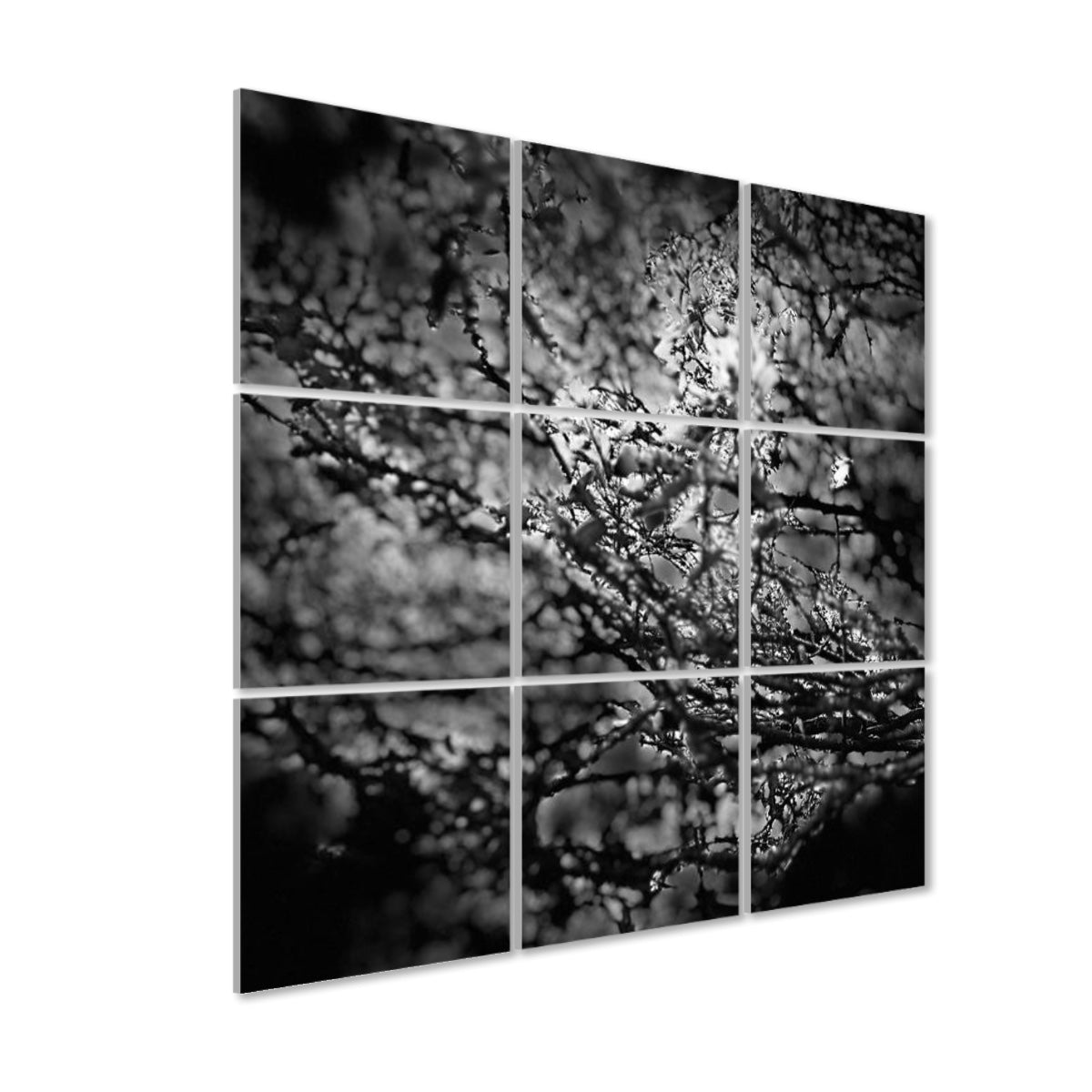 Left-angle view of Shadowed Canopy 9-panel wall art showing layered foliage and branch detail with a dreamy monochrome effect and visible panel depth