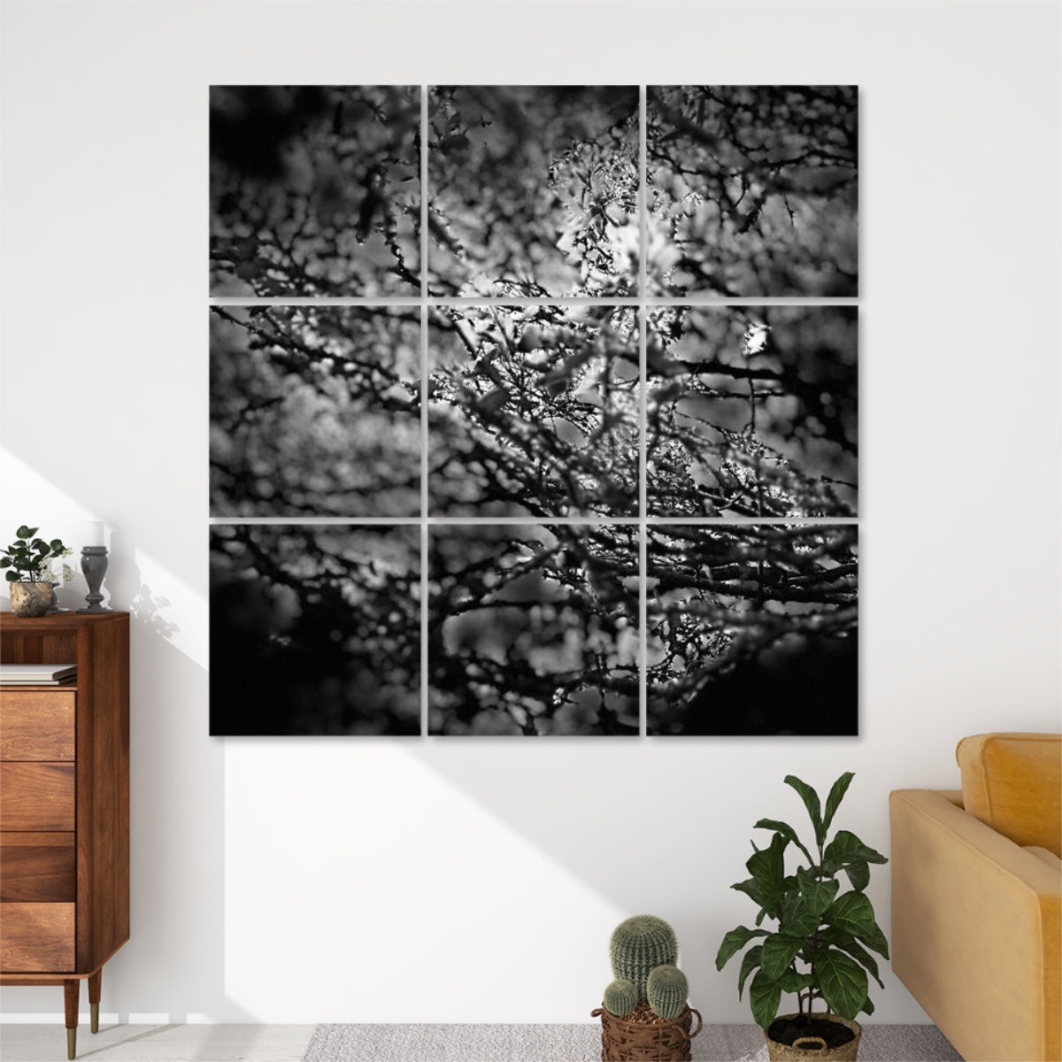 Front view of 9-panel acoustic wall art featuring a high-contrast black and white image of overlapping branches and leaves in soft focus, creating a moody, abstract texture.