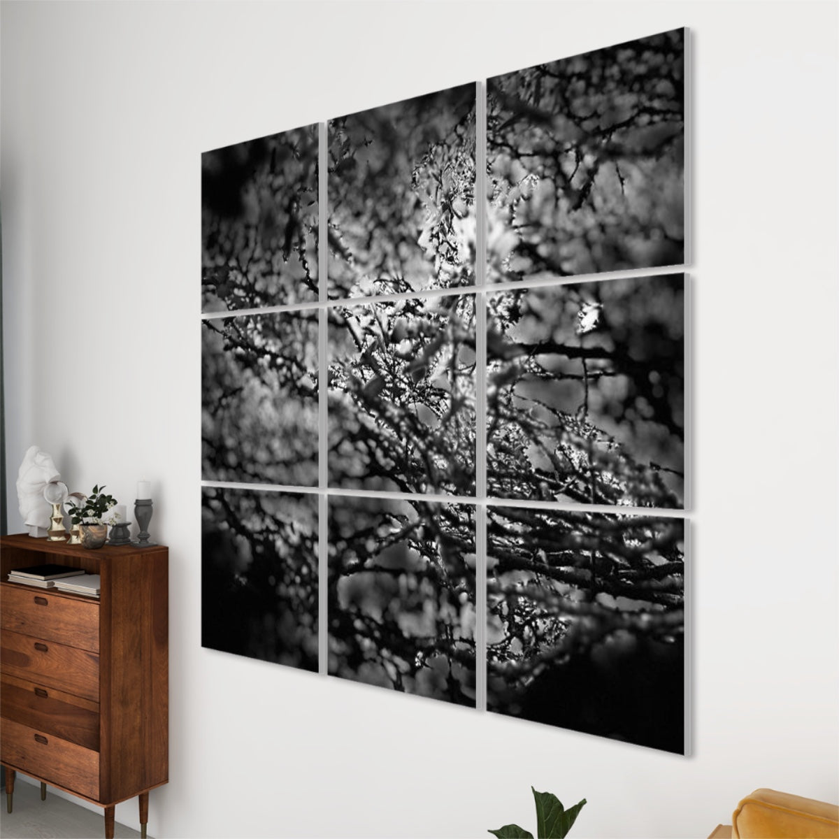 Right-angle view of 9-panel sound-absorbing wall art with soft-focus black and white tree branches forming a dense abstract canopy.