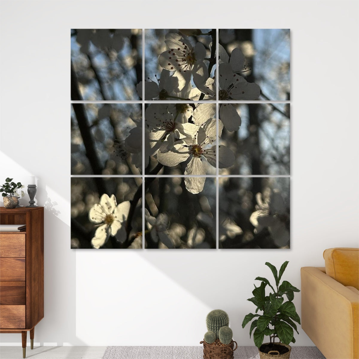 Front view of 9-panel acoustic wall art featuring white spring blossoms softly backlit by the sun, with a blurred forest background.