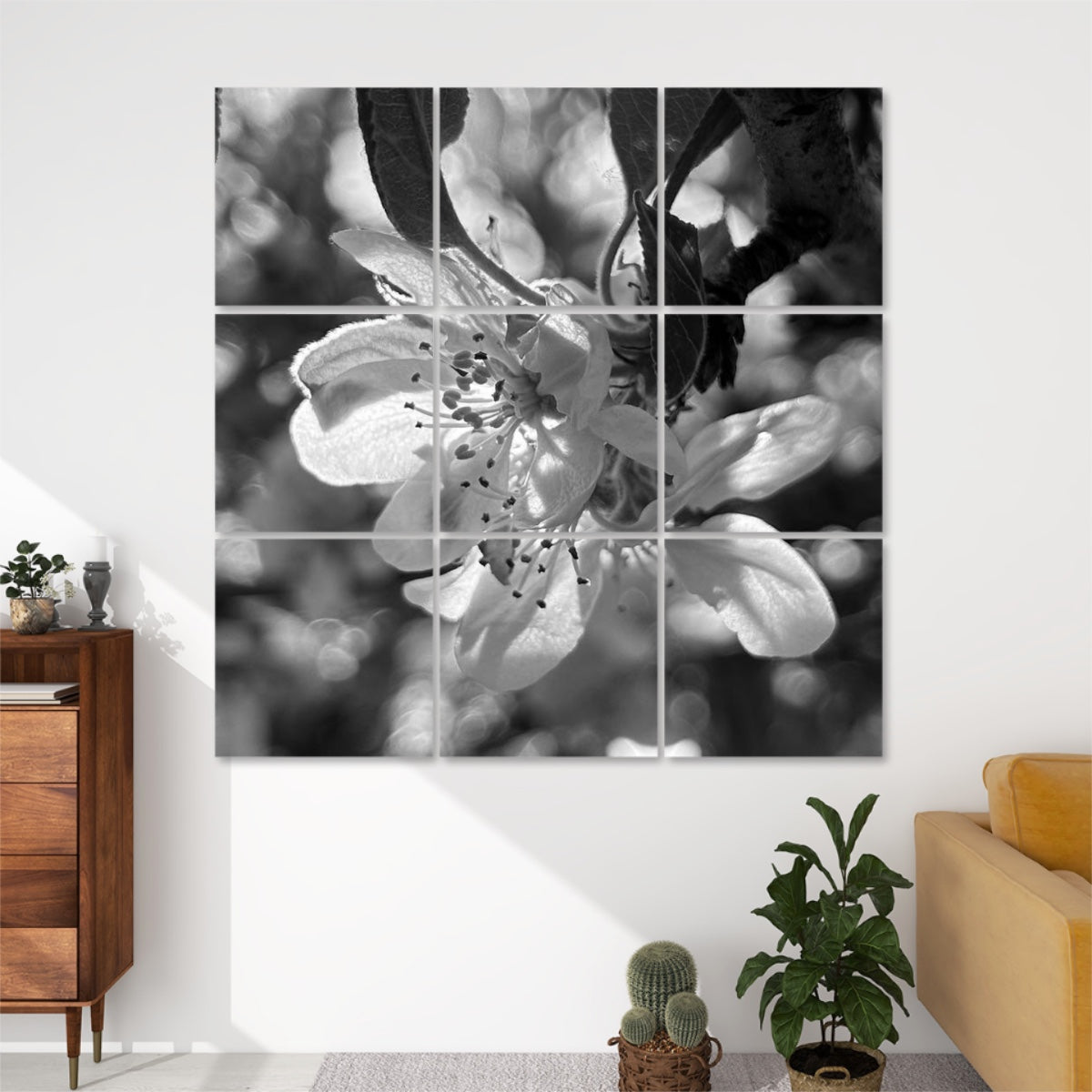Grayscale version of close-up floral image of softly lit petals and blurred background bokeh in warm blush tones, divided over 9 decorative sound absorbing wall panels.