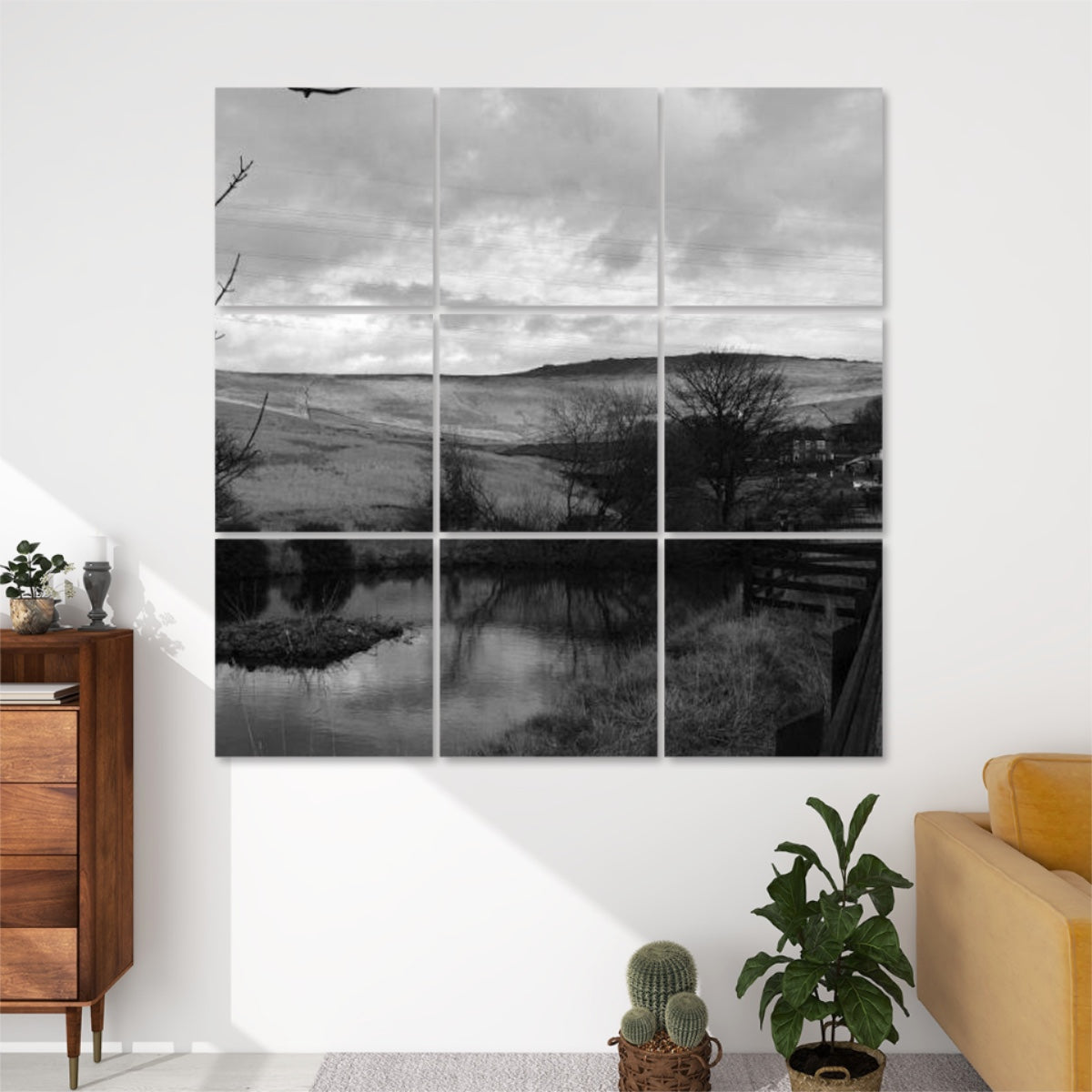 Greyscale 9-panel acoustic wall art of a British landscape with bare trees, hillside, pond reflections, and cloudy sky in soft monochrome tones.