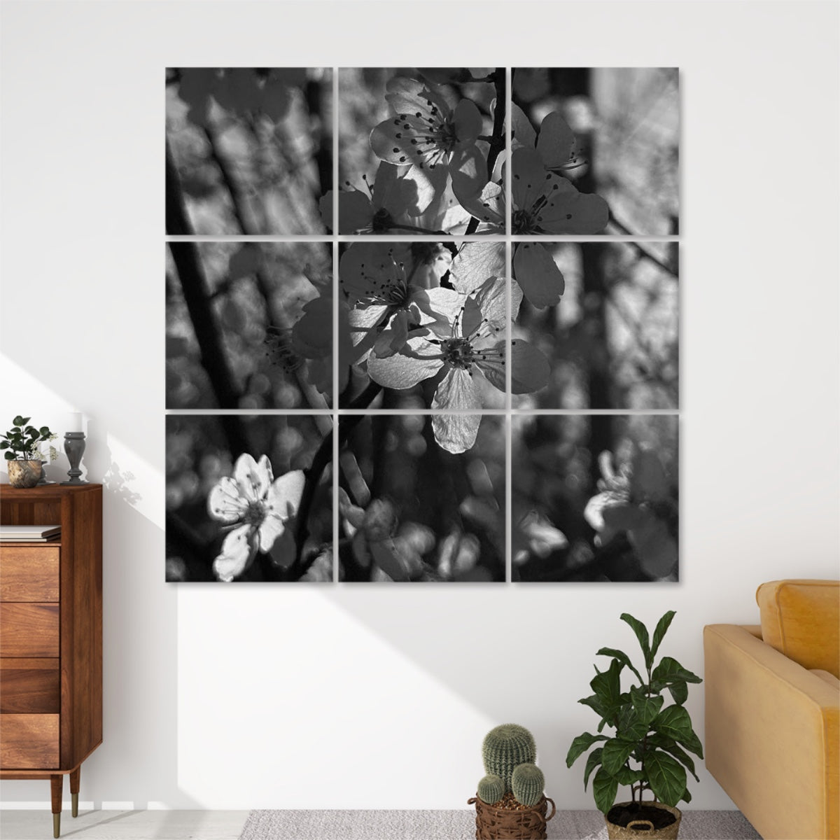 Greyscale 9-panel wall art of delicate backlit blossoms on branches, with soft monochrome tones and a moody forest background.