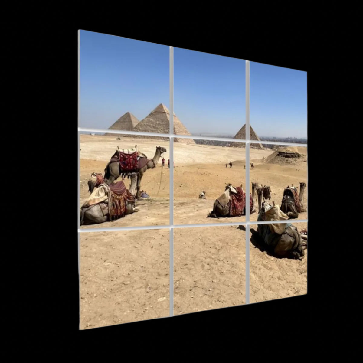 Left‑side angled view of the 3 × 3 full‑color camel‑and‑pyramids acoustic panel set, highlighting panel depth and vivid desert hues.