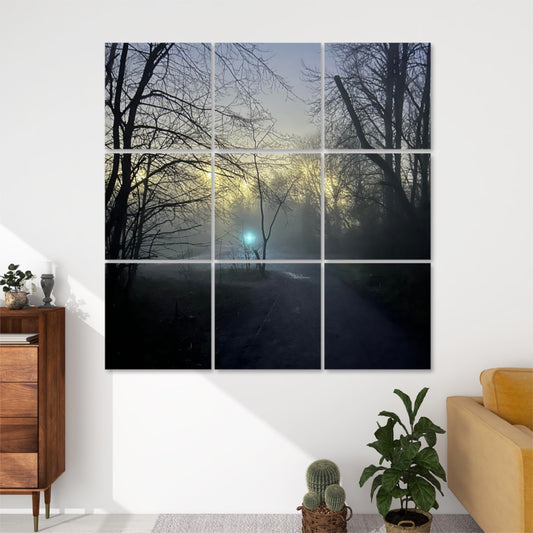 Front view of 9-panel acoustic wall art featuring a foggy forest path at dusk or dawn, with silhouetted trees and a glowing blue light in the distance.
