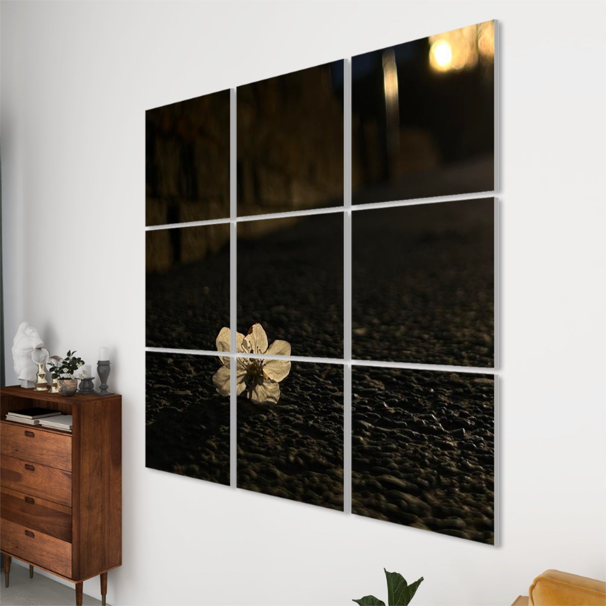 Right-angle view of 9-panel acoustic wall art featuring a close-up of a flower on asphalt in warm sunset tones.