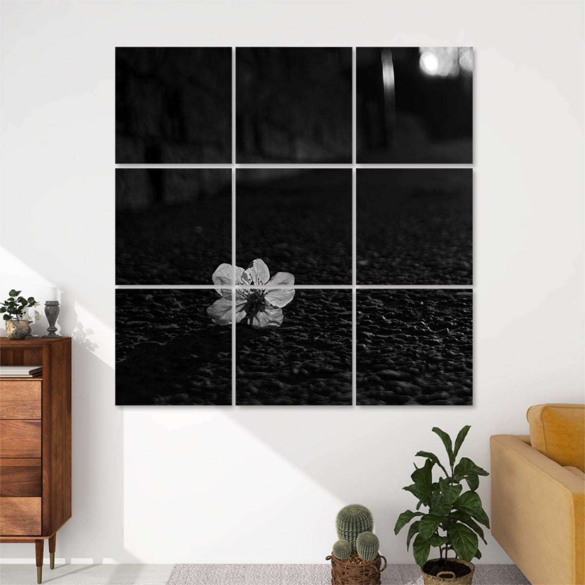 Front view of Asphalt Bloom 9-panel wall art in greyscale, featuring a delicate flower resting on textured pavement in soft monochrome tones.