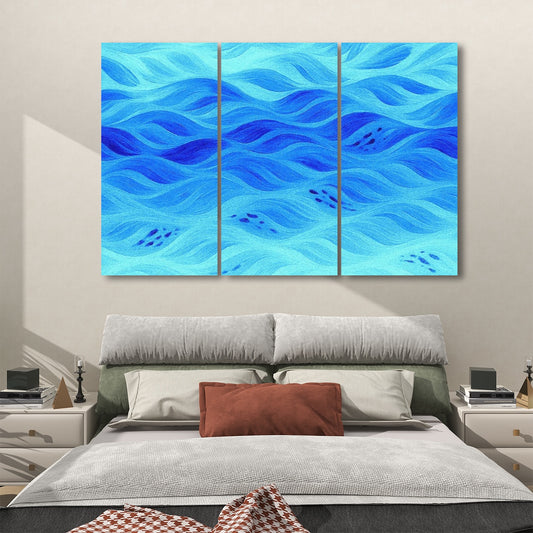 Three decorative acoustic panels in soft azure blue tones with flowing abstract design, displayed above a modern bed.