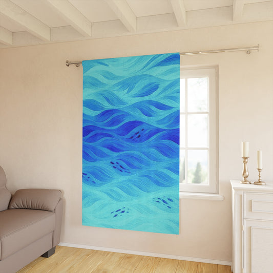 Bright turquoise blackout curtain with swirling deep blue current patterns, shown in a soft, beige interior space—50″ × 84″.