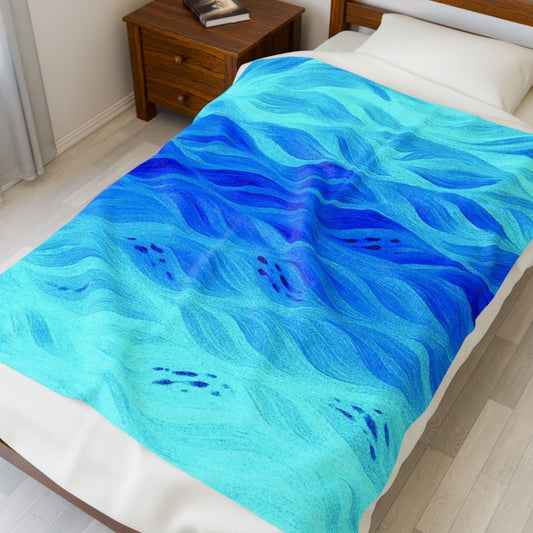 Bright aqua-blue throw blanket in azure variant, waves of color flowing diagonally across a twin mattress