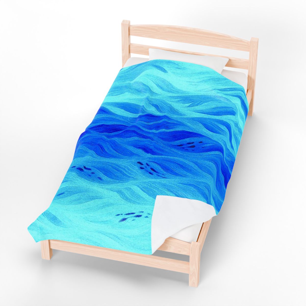 Plush velveteen blanket in azure tones, depicting rippling water-like patterns on a bed with natural light