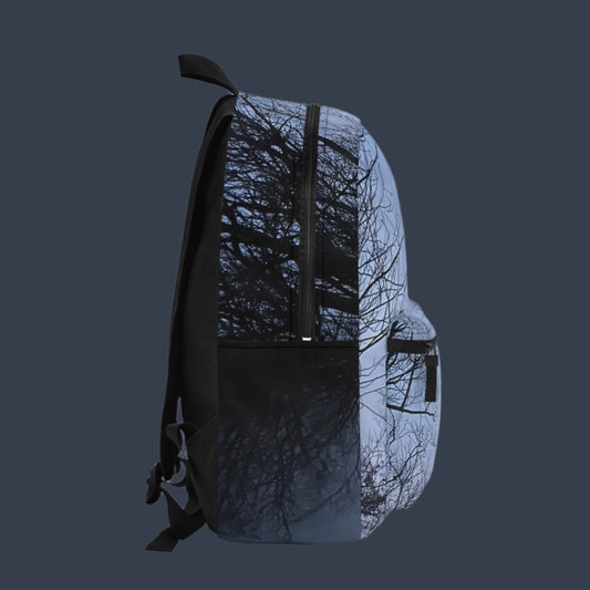 Left side of moody nature backpack showing foggy tree design wrapping around with side pocket.