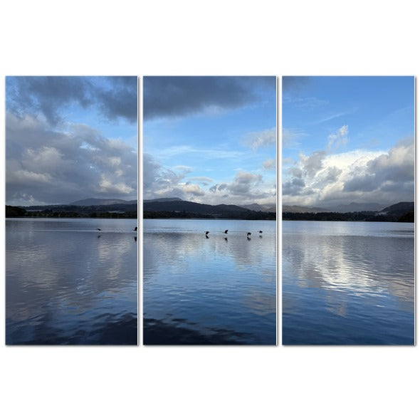 Stunning triptych of Birds Flying Over Windermere Lake - Lake District Landscape with calm waters and blue sky