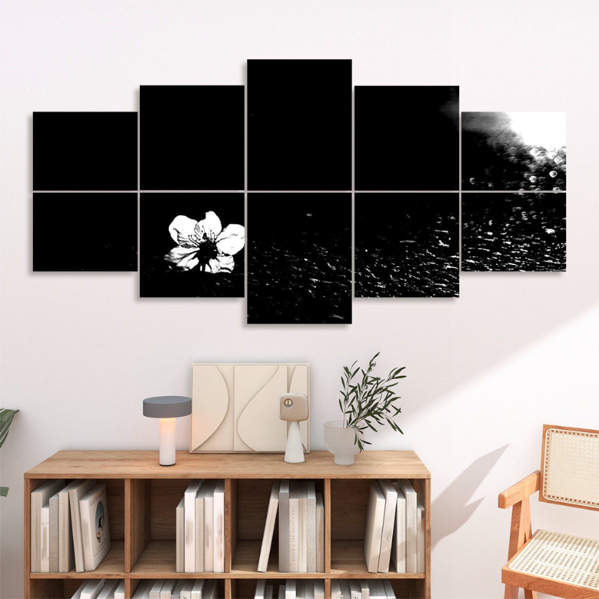 Black and white version of a pale blossom lying on asphalt, divided over 10 sound absorbing wall panels with strong tonal contrast.
