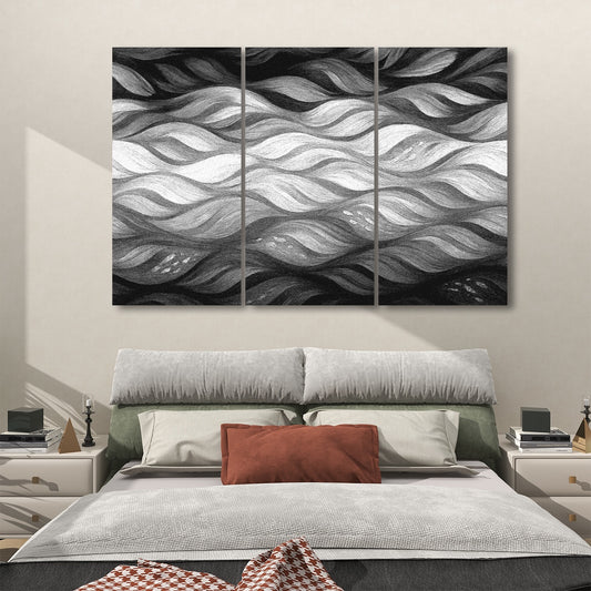 Black and white triptych acoustic panels featuring bold wave structure, mounted above a minimalist bedroom setting