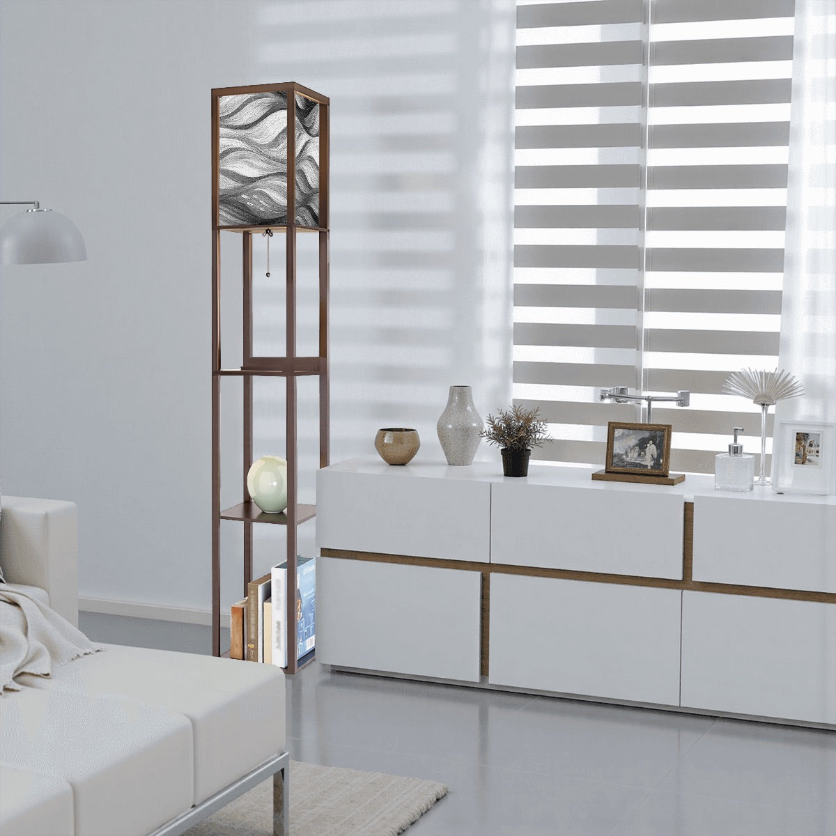 Walnut-finish wood floor lamp with three square shelves displaying a vase and books, topped by a linen cube shade in bold black-and-white wavy abstract design. A metal pull-chain switch and black power cord are visible beneath the shade.