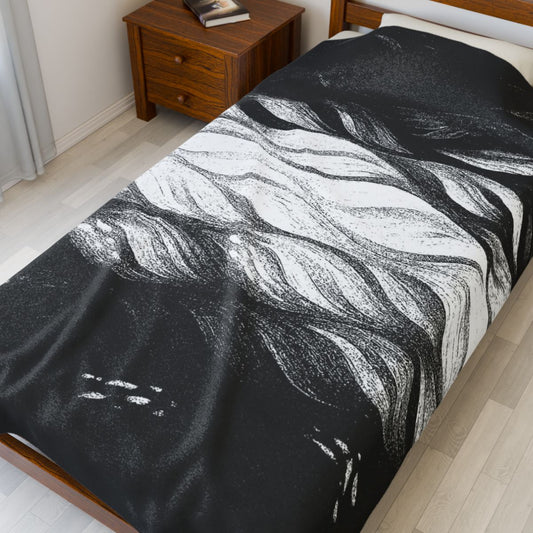 Plush black and white velveteen blanket with abstract linework and contrast, shown on a queen-sized bed