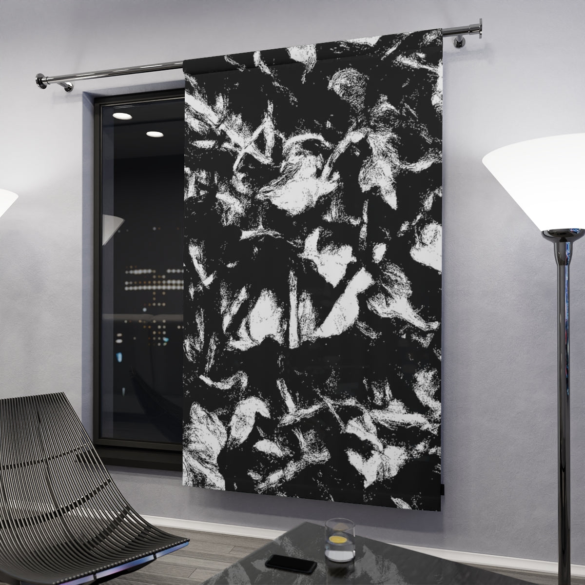 Monochrome variant displayed in a dark modern space, abstract foliage pattern catching light from nearby lamps and night window glow