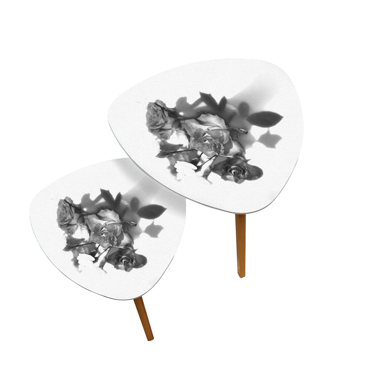 set of 2 black and white triangular coffee tables featuring bouquet of roses
