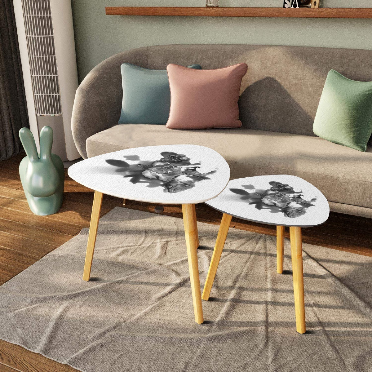 set of 2 black and white triangular coffee tables featuring bouquet of roses