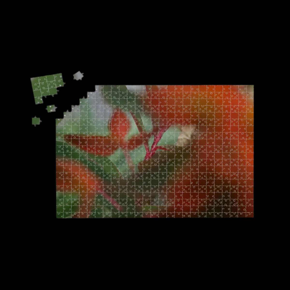 Wooden jigsaw puzzle of red and green foliage in full color with artistic bokeh, soft abstract nature scene