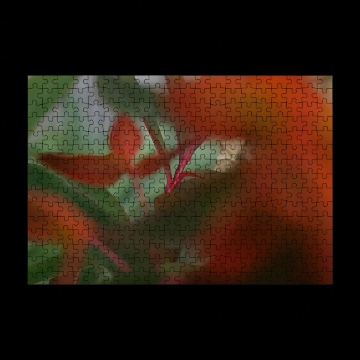 Wooden jigsaw puzzle of red and green foliage in full color with artistic bokeh, soft abstract nature scene