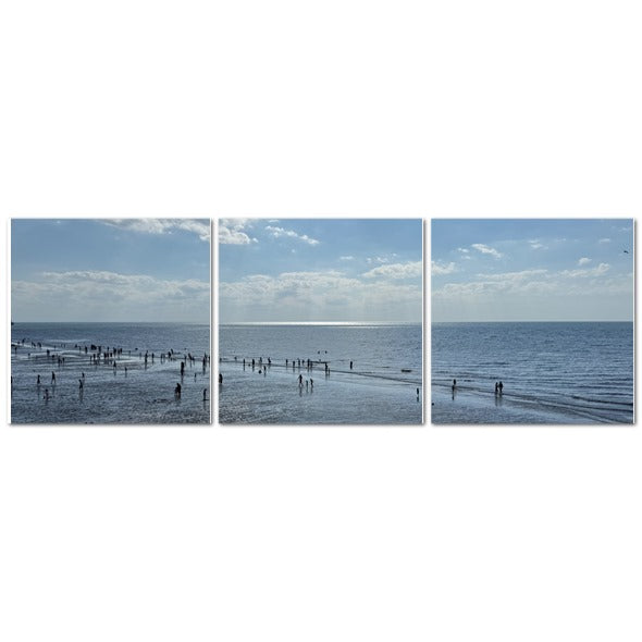 Made in UK Triptych Canvas featuring Beach in Shadow with Sunlight on the Horizon. Three panel seascape with people wading.