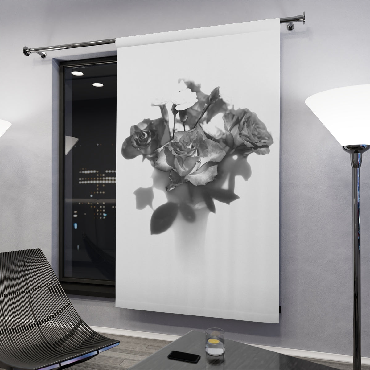 Curtain in evening setting: Grayscale rose blackout curtain in a modern room with floor lamps and city lights visible through a large window – 50" × 84".