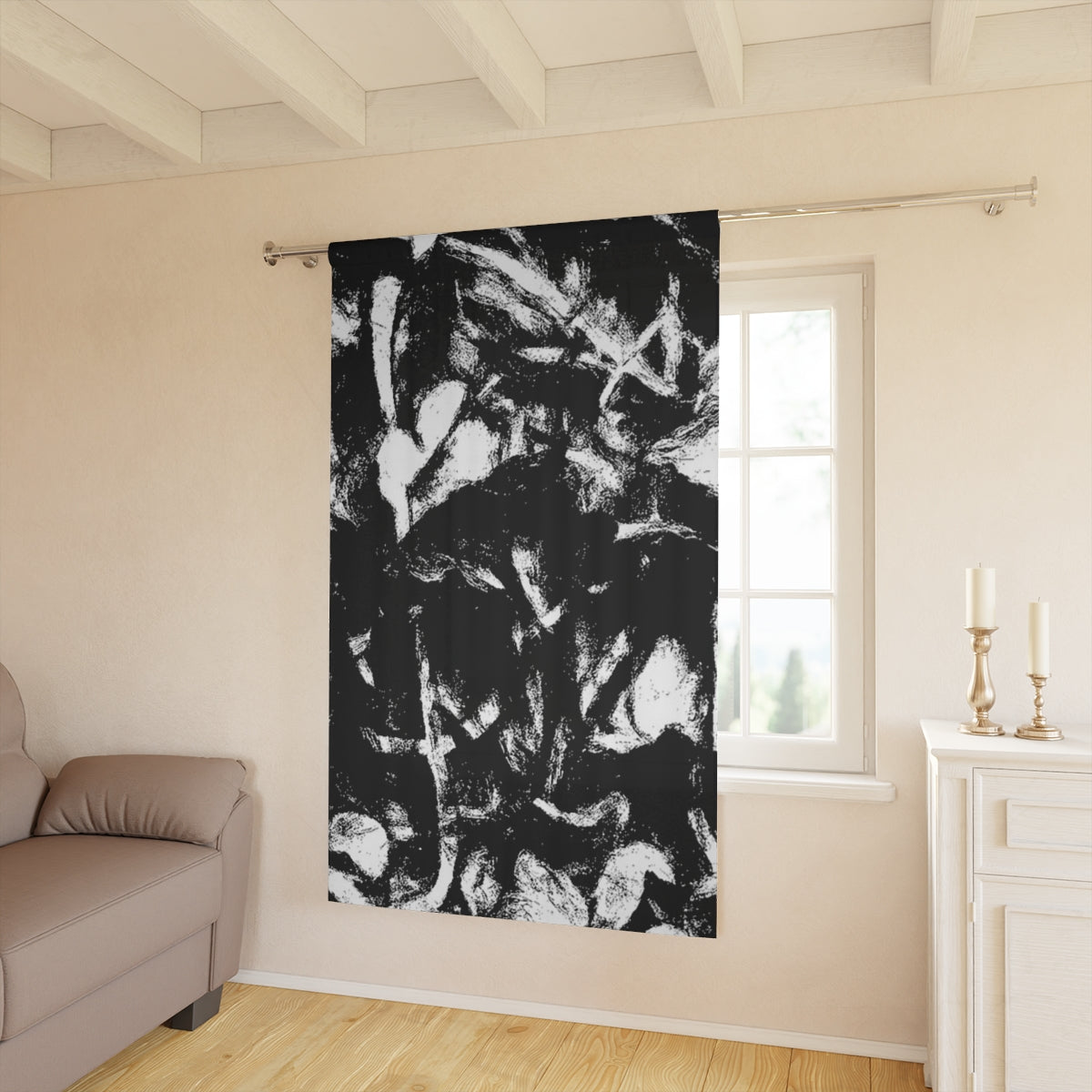 Black and white Leaf Tone with clef curtain hanging in a sunlit interior, its bold contrasts adding structure to a soft, neutral-toned room