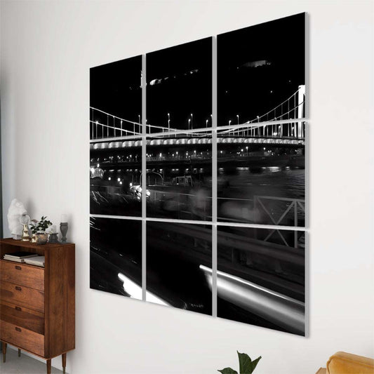 Night view of Elisabeth Bridge in Budapest with glowing streetlights, traffic light trails, and river reflections.